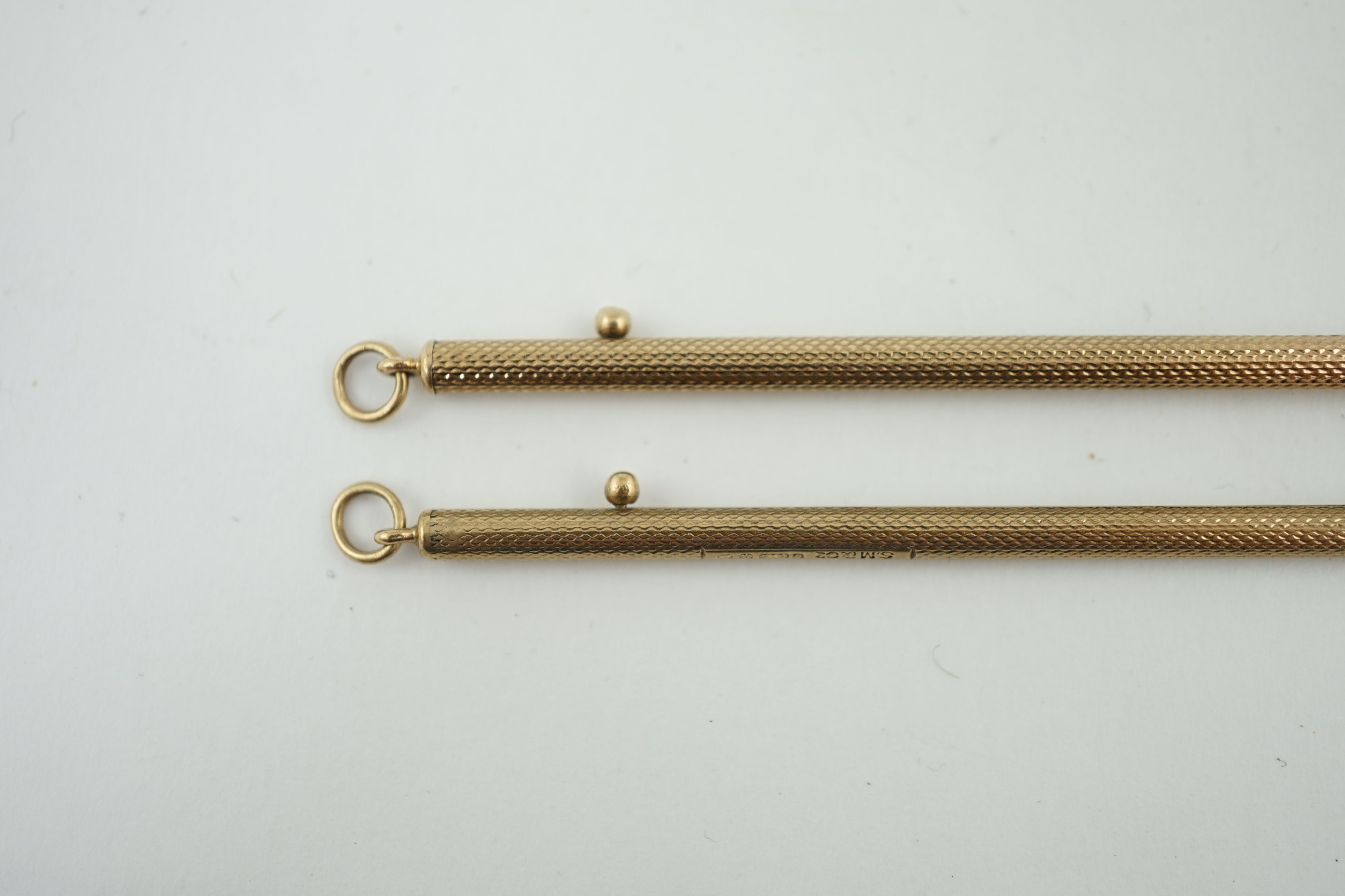 A pair of George V engine turned 9ct gold swizzle sticks, by Sampson Mordan & Co, London, 1934